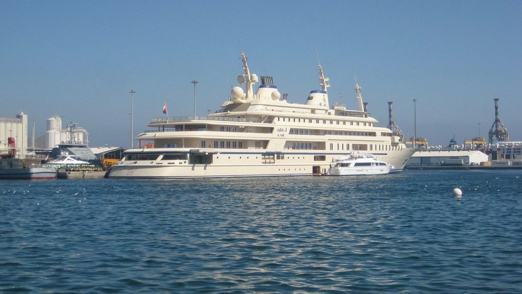 Super yacht Al Said docked next to a small boat