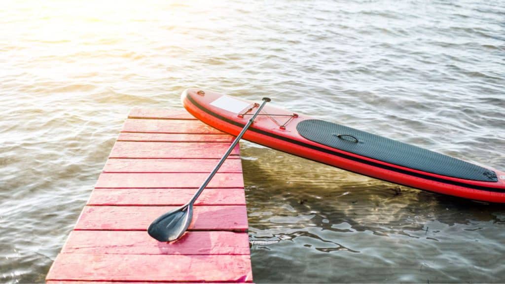 ocean paddleboard and paddle on a dock